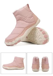 Detail view of pink quilted waterproof snow boots with thick white faux fur lining and soles