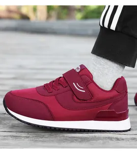 Detail shot of wine red walking shoes featuring mesh fabric and secure velcro closure