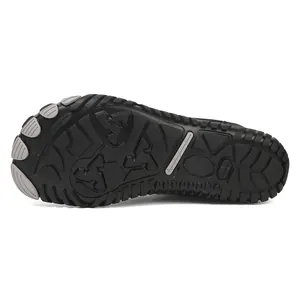 Macro shot of black winter barefoot shoe outsole with anti-slip rubber grip pattern