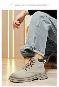 Close-up of light grey leather work boots with non-slip thick rubber soles and laces