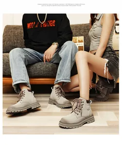 Close-up of khaki leather ankle boots with thick rubber soles on a modern sofa background