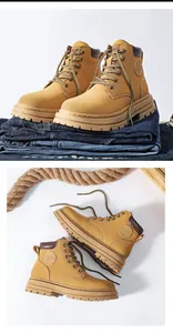 Detailed macro of tan leather work boots with 6-eyelet lacing and thick rubber soles