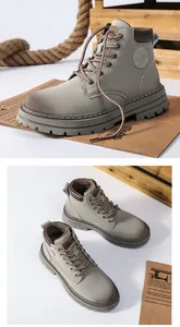 Detail of matte gray high-top Martin boots featuring thick rubber soles and durable laces