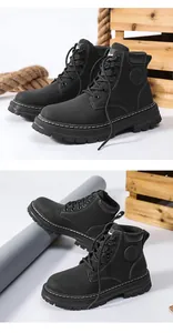 Detail of black leather work boots featuring thick lug soles and white contrast stitching