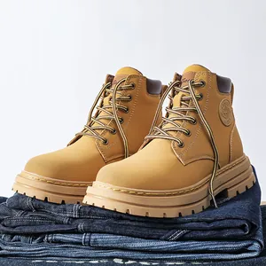 Detailed close-up of khaki nubuck leather work boots showing thick anti-slip rubber soles