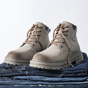 Detail view of khaki leather work boots with non-slip thick soles and 6-hole lacing