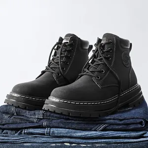 Black leather high-top work boots with contrast white stitching and thick rubber sole