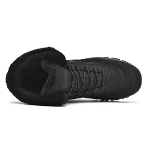 Close-up of black waterproof snow boots with thick faux fur lining and lace-up design
