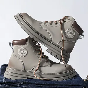 Detail view of khaki leather work boots with non-slip thick soles and sport fashion logo