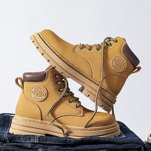 Detail of camel nubuck work boots featuring sports fashion logo and thick rubber sole
