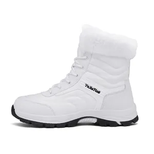 Close-up of white waterproof snow boots with fluffy faux fur collar and anti-slip rubber sole