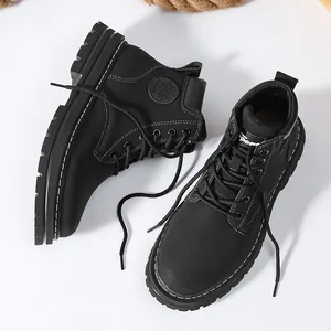 Detail view of black high-top outdoor boots with fashion embossing and contrast stitching