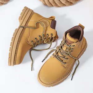 Close-up of classic yellow leather work boots with thick rubber soles and sports embossing
