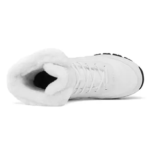 Close-up of winter snow boots featuring warm white faux fur lining and lace-up design