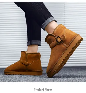 Detail view of tan leather snow boots with buckle strap and warm faux sheepskin lining