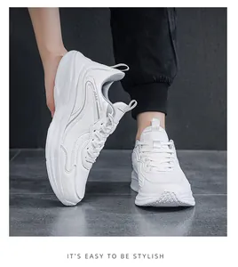 Side view of white leather platform sneakers on feet showing thick soles and lacing