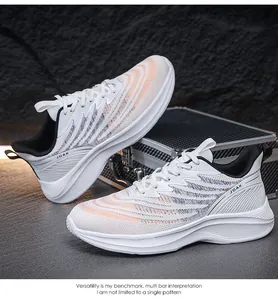 Detail shot of breathable white mesh running shoes with orange accents on dark rock surface