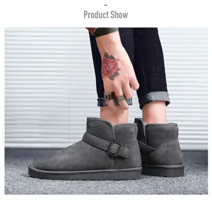 Detail view of dark grey suede snow boots featuring metal buckle strap and thick rubber sole