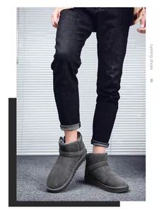 Detailed view of dark grey suede snow boots with thick plush lining and side buckle detail