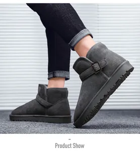 Close-up of dark grey suede snow boots with metal buckle and anti-slip rubber sole