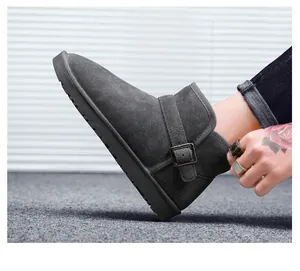 Detail view of dark grey suede snow boot featuring a side buckle and non-slip sole