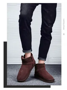 Detailed close-up of brown suede snow boots featuring buckle strap and warm plush lining