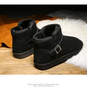 Detailed view of black leather snow boots with buckle strap and thick warm faux fur lining