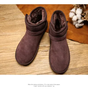 Close-up of classic leather snow boots with thick faux fur lining and buckle detail