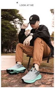 Outdoor shot of men's gradient grey running shoes with mint green shock-absorbing soles