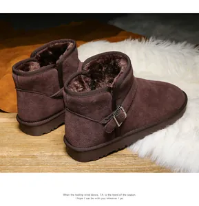 Detail view of deep brown suede snow boot with plush faux fur lining and buckle