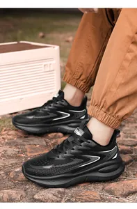 Macro detail of men's black running shoes with breathable mesh and side lettering