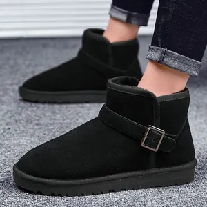 Classic black leather snow boots with metal buckle and warm fur lining on a grey rug