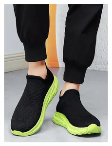 Detailed shot of breathable knit sneakers featuring neon green thick platform outsoles
