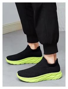 Close-up of knit upper texture and neon green sole of these slip-on running sneakers