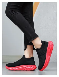 Detail showing red thick sole and black knit texture of the casual sport sock sneaker