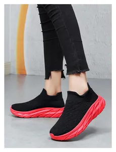 Close-up of black breathable knitted sock sneakers with a thick red shock-absorbing sole