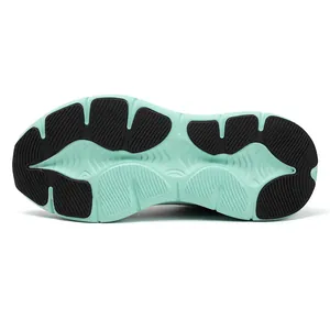 Detail of mint green and black sneaker outsole featuring anti-slip rubber traction pattern