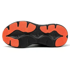 Detail view of the black and orange anti-slip rubber outsole with deep traction patterns