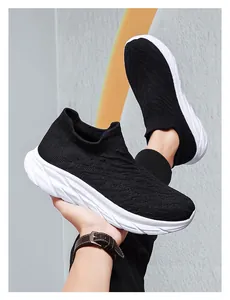 Close-up of black breathable knit sneakers featuring thick white shock-absorbing soles