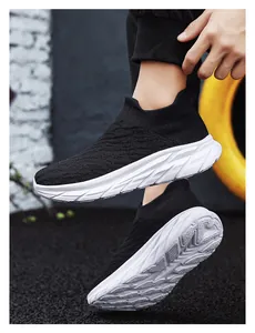 Close-up of black breathable knit upper and chunky white geometric sole on a sock sneaker