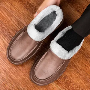 Detailed close-up of brown leather winter loafer showing thick grey plush warm lining