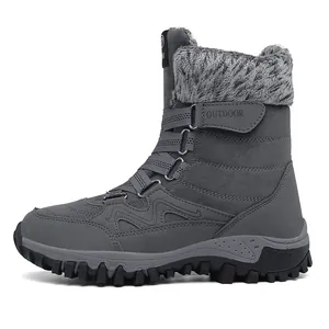 Close-up of dark grey snow boot with warm faux fur lining and outdoor grip sole
