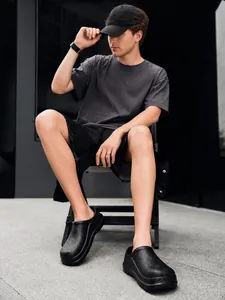 Detail of black non-slip chef shoes with EVA texture on male model for kitchen work