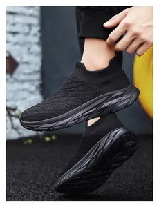 Detail of men's black knit slip-on sock sneakers with textured wave patterns and thick soles