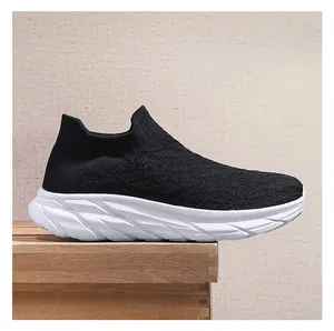 Side view of black breathable knit sock sneaker with a thick textured white sole