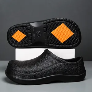 Detail view of anti-slip chef shoes with orange rubber grip soles and waterproof EVA texture