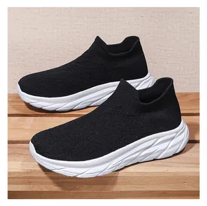 Detail of black knit sock shoes featuring breathable fabric and chunky white soles