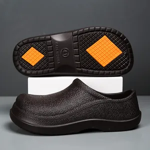 Detail of dark brown chef shoe with non-slip orange tread pattern and size 41 marking
