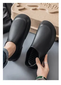 Detailed view of the anti-slip checkered footbed on waterproof black chef work shoes