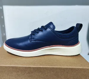 Detail of navy blue leather oxford shoe with white wavy sole and contrast stitching